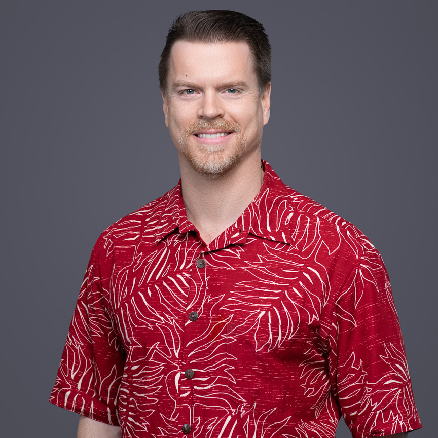 Murray Clay, outgoing president, standing in front of a building.